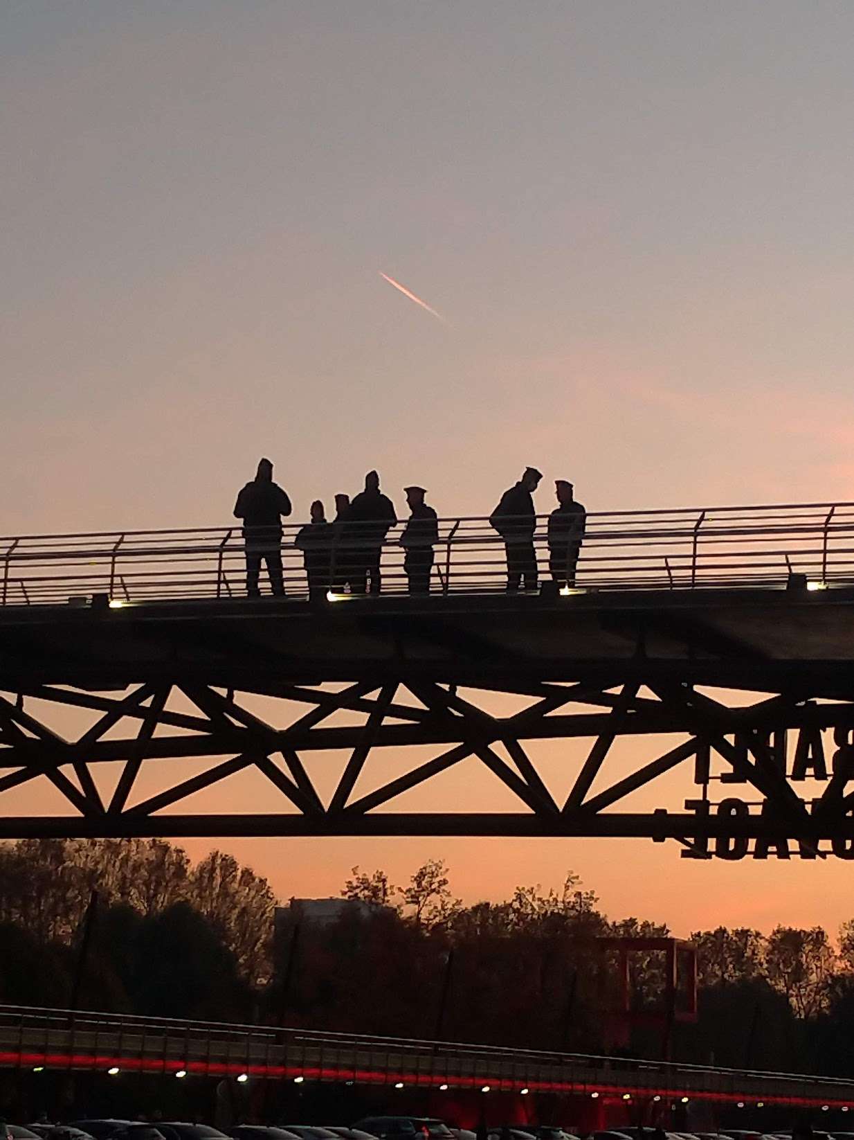 a group of people standing on a bridge on the canal saint-martin near La Villette 