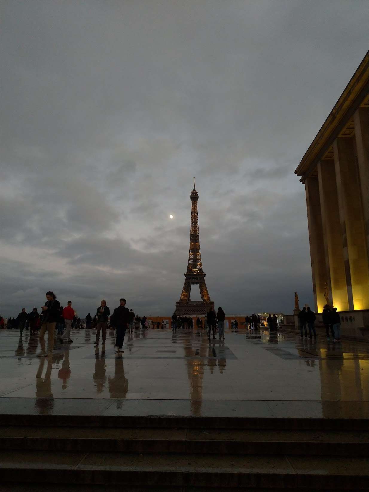 Eiffel tower, a large tower with people walking around on place du Trocadero